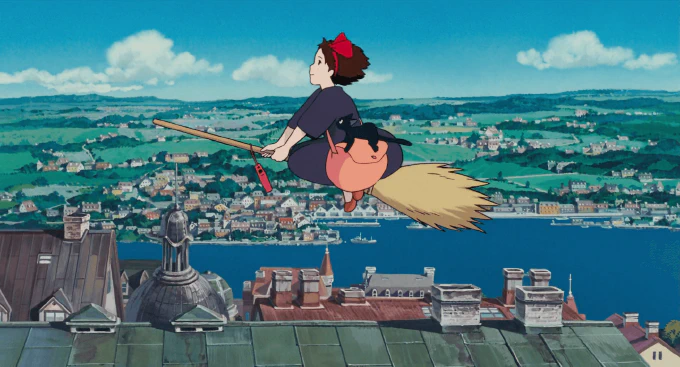 **Fig. 2.1** *Kiki soars high above the roofs of Koriko on her broomstick* Image of Kiki soaring above rooftops on a broomstick